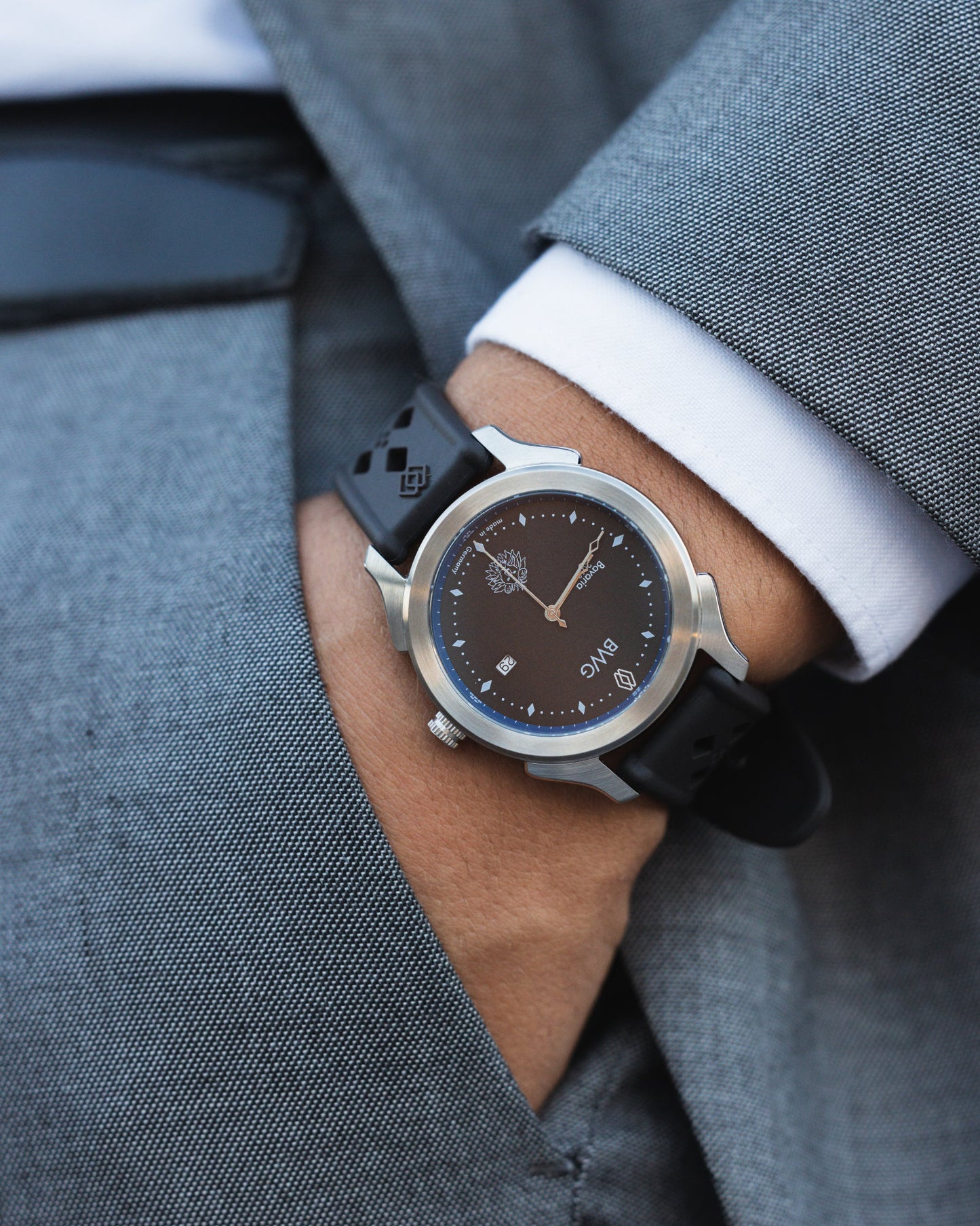 Young man in suit wears a BWG BAVARIA good design awarded premium quartz watch with Swiss made Ronda moment in slate black slick elegant design