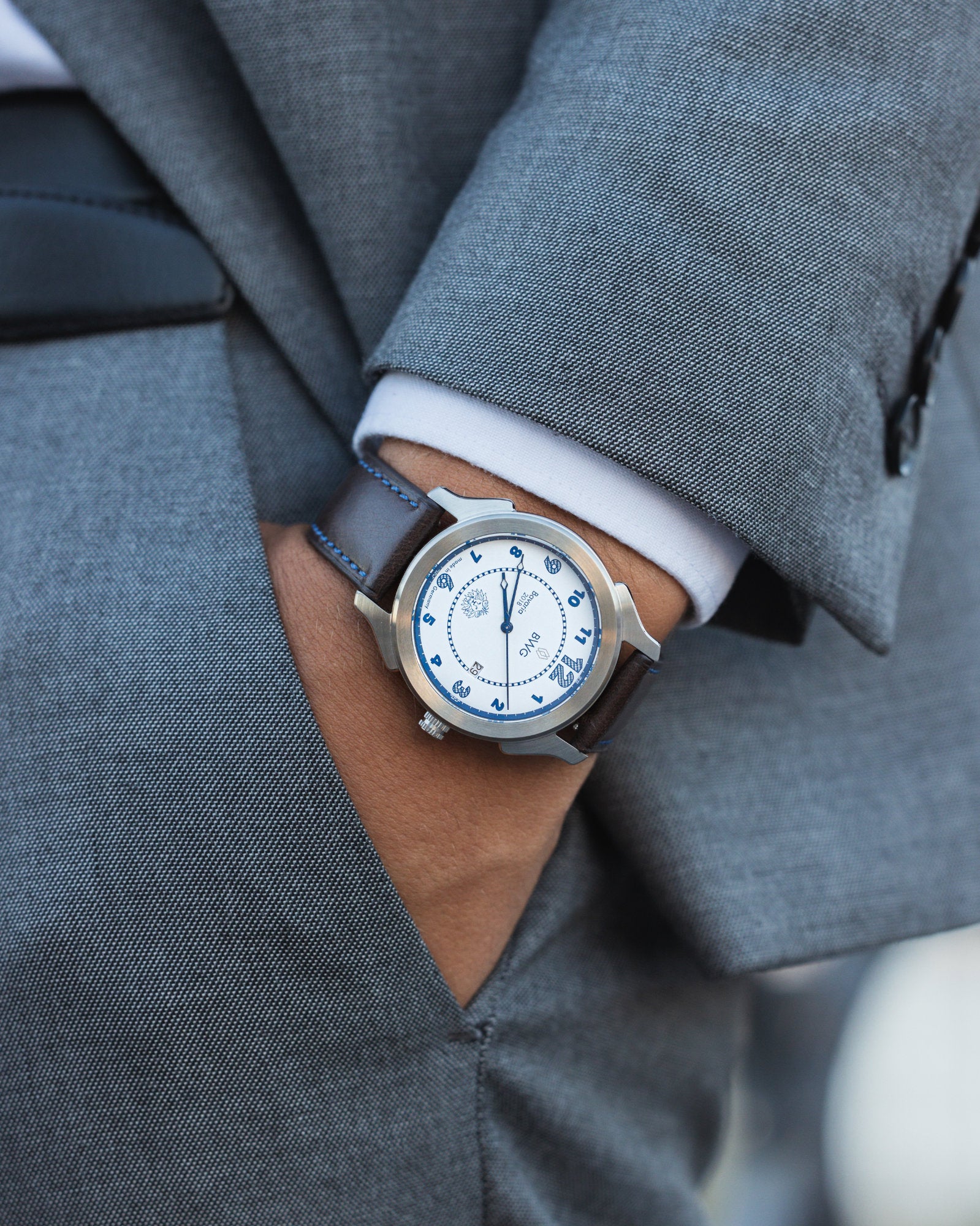 Man in suit wears a BWG Bavarian Watch BAVARIA Glacier White Sport premium quartz watch with Swiss made Ronda movement 