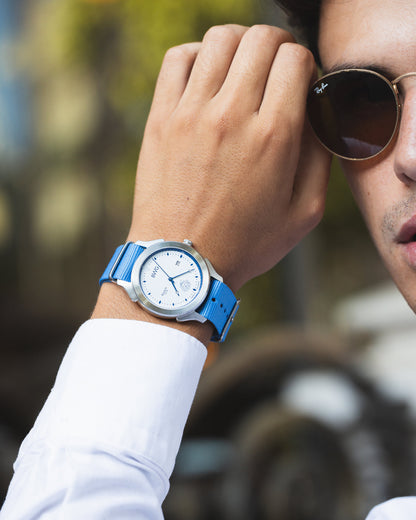 Man wears a BWG Bavarian Watch BAVARIA Glacier White premium quartz watch with Swiss made Ronda movement on a sky blue Nato textile strap wearing sunglasses