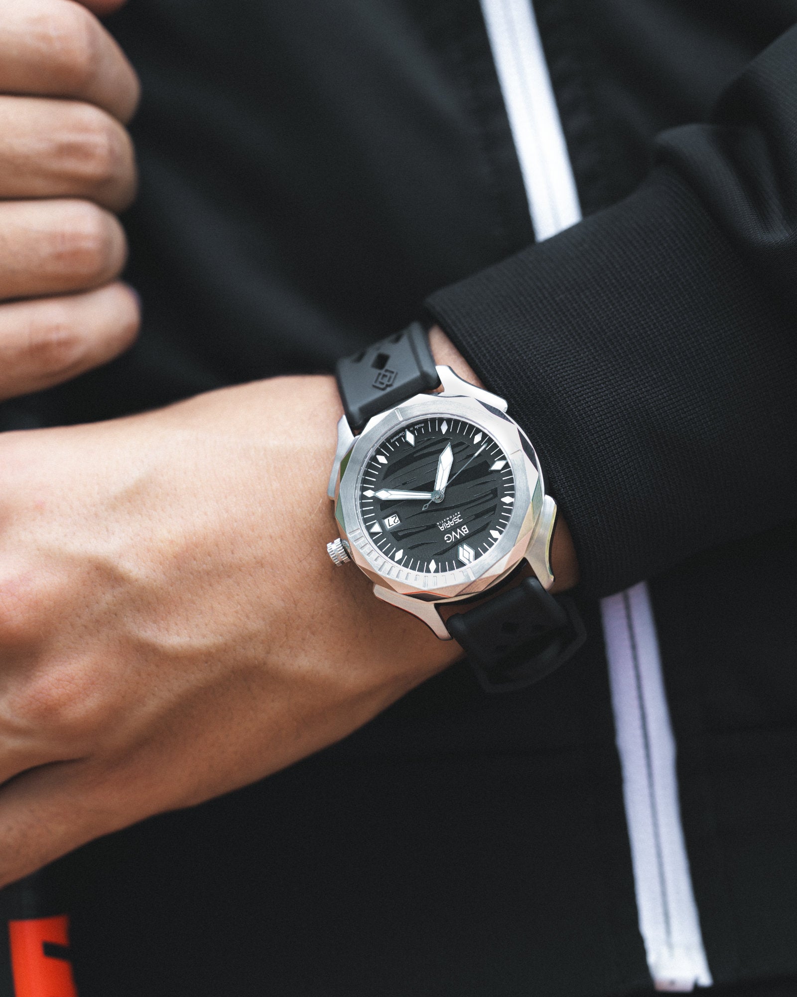 Young man wearing a ISARIA slate black automatic watch with Swiss Landeron L24 manufacture movement