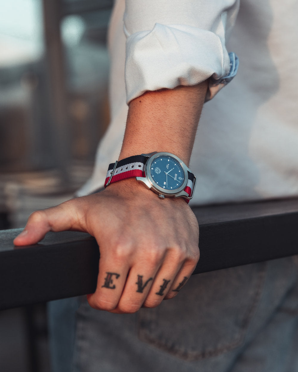 Man with tattooed hand wears a BWG Bavarian watch BAVARIA GOOD Design awarded Premium Quartz Watch with Swiss Ronda Movement