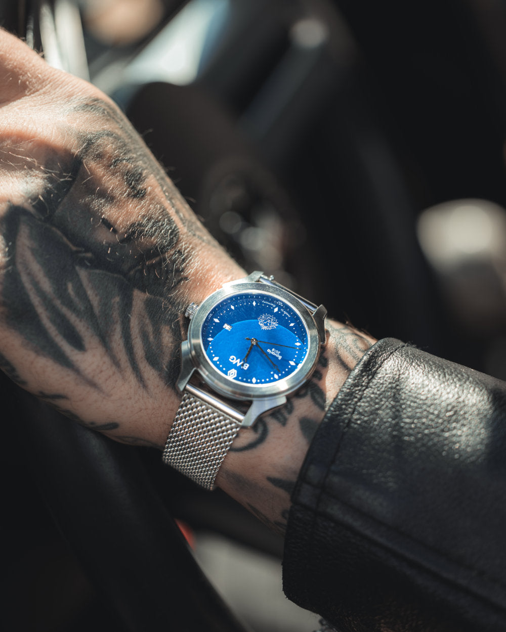 Man with tattooed hand wears a BWG Bavarian watch BAVARIA GOOD Design awarded Premium Quartz Watch with Swiss Ronda Movement driving a Mustang