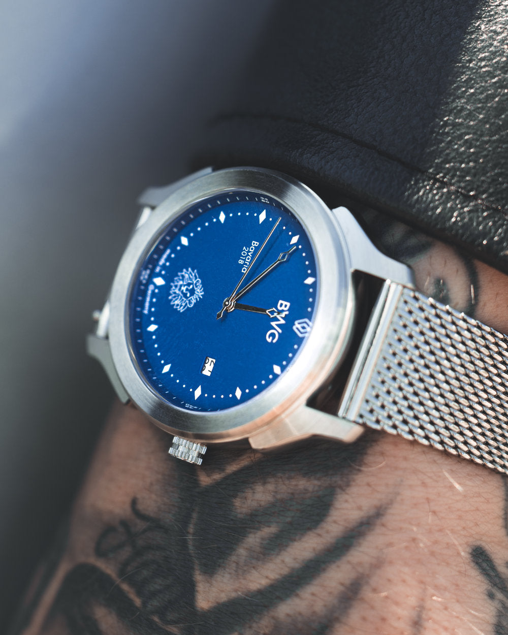 Man with tattooed hand wears a BWG Bavarian watch BAVARIA GOOD Design awarded Premium Quartz Watch with Swiss Ronda Movement